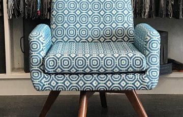 Chill swivel chair upholstered in geometric patterned Warwick fabric.